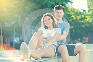 Young man is hugging his girlfriend