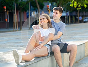 Young man is hugging his girlfriend
