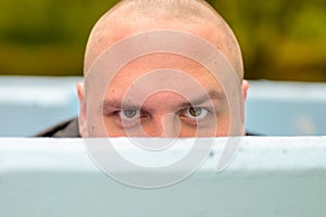 Young man hunkering down in an outdoor tub or pool