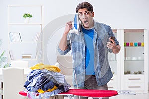 The young man husband doing clothing ironing at home