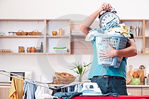 The young man husband doing clothing ironing at home