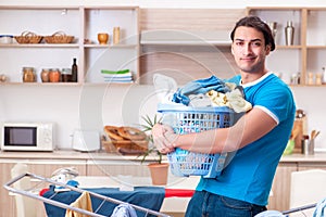 The young man husband doing clothing ironing at home