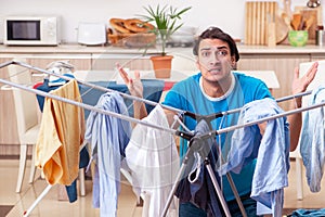 The young man husband doing clothing ironing at home