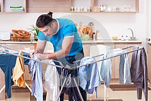 Young man husband doing clothing ironing at home