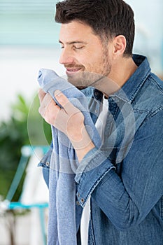 young man husband doing clothing ironing at home