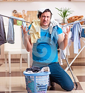 Young man husband doing clothing ironing at home