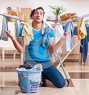 Young man husband doing clothing ironing at home