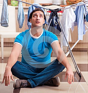 Young man husband doing clothing ironing at home