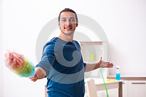 Young man husband doing housework at home
