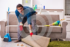 Young man husband doing housework at home