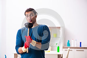 Young man husband doing plumbing at home