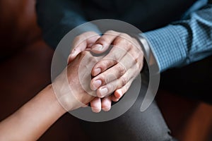Young man husband holding hand of beloved wife asking forgiveness