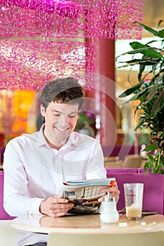 Young man in ice cream parlor