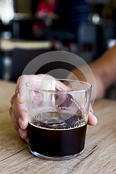 Young man with an iced coffee in a coffeehouse