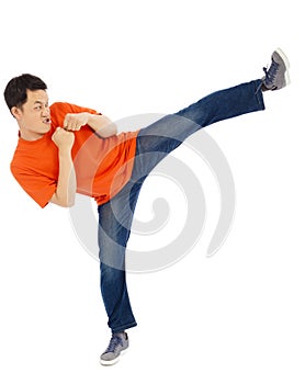 Young man imitate a Karate to do standing side kick