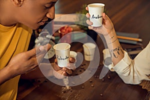 Young man inhaling the aroma of a caffeinated beverage