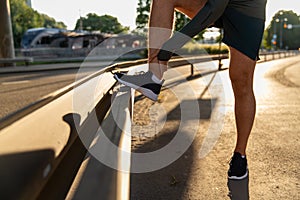 young man with injured or leg under bridge