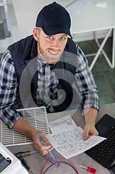 Young man installing device reading manual photo