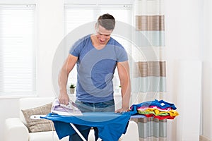 Young Man Ironing Clothes