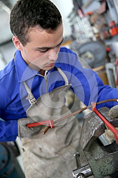 Young man in ironworks training