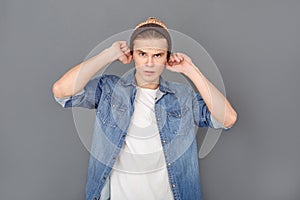 Young man in jeans jacket studio isolated on grey stylish