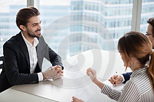 Young man at job interview answering questions of employer.