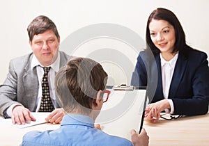 Young man during job interview and members of managemen