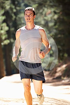 Young man jogging through the countryside