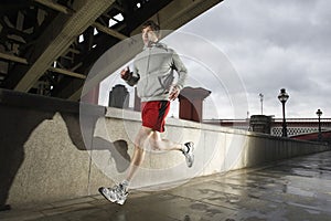 Young Man Jogging On Stormy Day