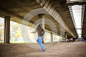 Young man Jogging under bridge.