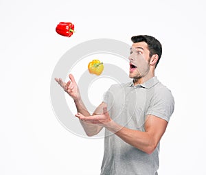 Young man juggling pepper
