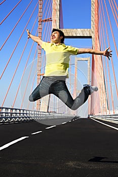 Young man jump very high in bridge area