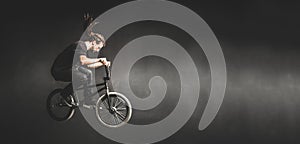 Young man jumping on BMX bicycle