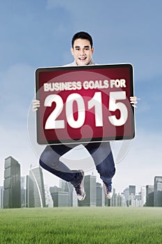 Young man jumping with business goals