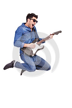 Young man jumping with guitar