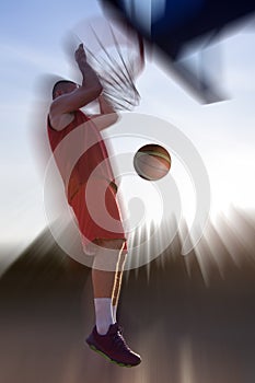 Young man jumping and making a fantastic slam dunk playing stree