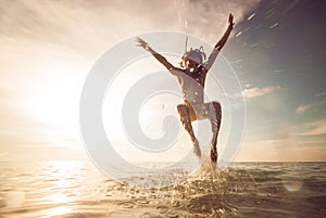 Young man jumping in the sea