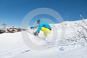 Young man jumping with snowboard