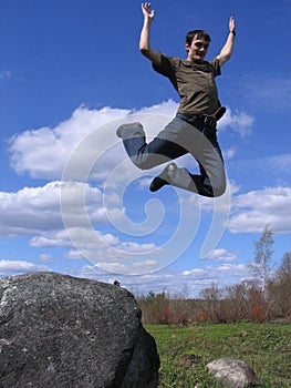 Young man jumping from stone 2