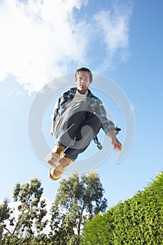 Young Man Jumping On Trampoline Caught In Mid Air