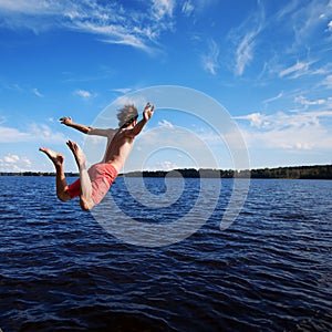 Young man jumping into water