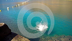 Young man jumping into water. Rest on the ocean