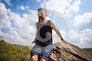 Young man jumps from the top of the rock