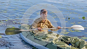 Young man in kayak. Ecotourism, visiting fragile, undisturbed natural areas. Active holidays photo