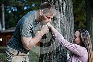 Young man kissing the hand of a woman outdoors