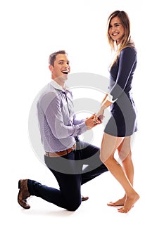 Young man kneeling in front of his girlfriend