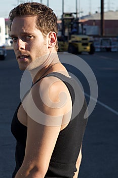 Young Man Kneeling next to train tracks