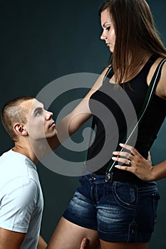 Young man kneels before his girlfriend