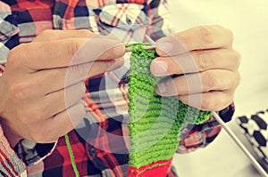 Young man knitting