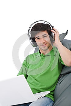 Young man with laptop and headphones